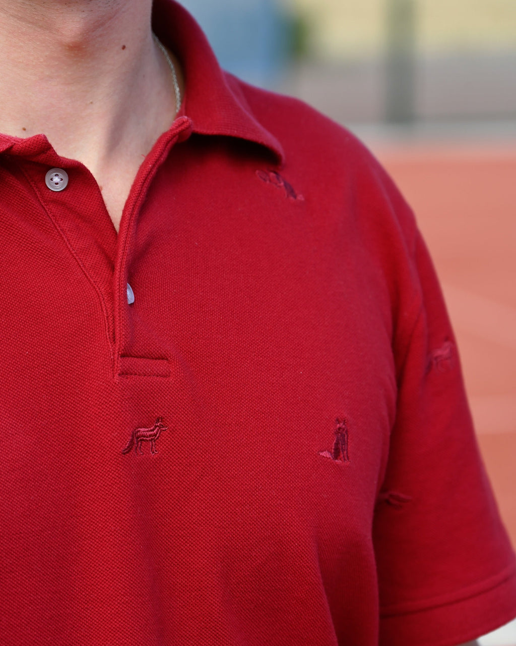 Embroidered foxes across the chest of the Fox Polo
