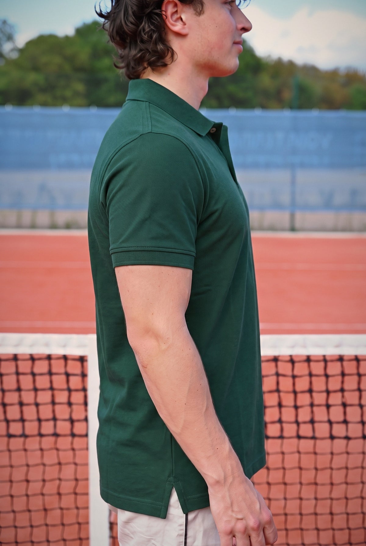 The Founder's Polo in forest green, side profile